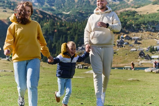 A modern family, along with their son, revels in the joy of a muddy day in nature, running and playing together, encapsulating the beauty of a healthy and active lifestyle.