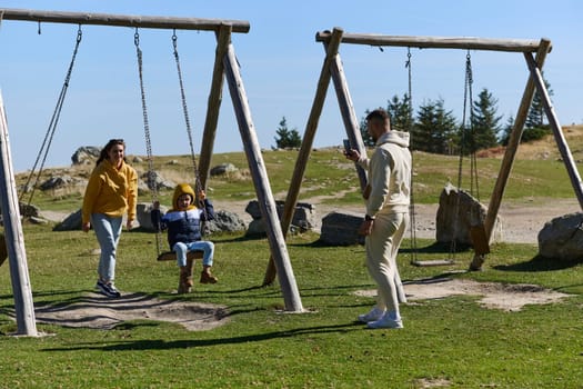 A modern family, along with their son, revels in the joy of a muddy day in nature, running and playing together, encapsulating the beauty of a healthy and active lifestyle.