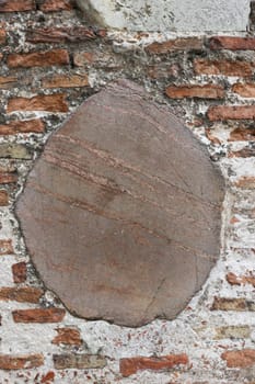 ..Medieval wall made of bricks and stone. Abstract background.