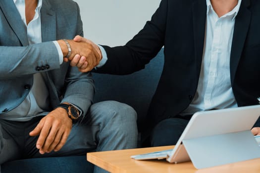 Businessman handshake with another businessman partner in modern workplace office. People corporate business deals concept. uds