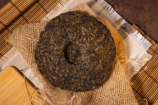 Shaped puerh tea on parchment paper, close up. Traditional ceremony