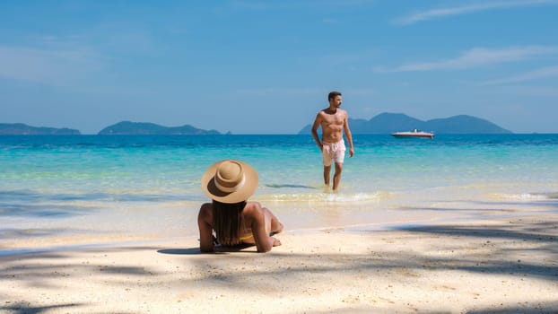 Koh Wai Island Trat Thailand is a tinny tropical Island near Koh Chang. a young couple of men and women on a tropical beach during a luxury vacation in Thailand