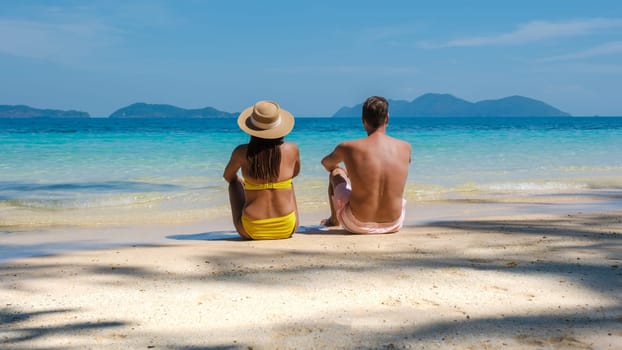 Koh Wai Island Trat Thailand is a tinny tropical Island near Koh Chang. a young couple of men and women on a tropical beach during a luxury vacation in Thailand, couple lying down on the beach