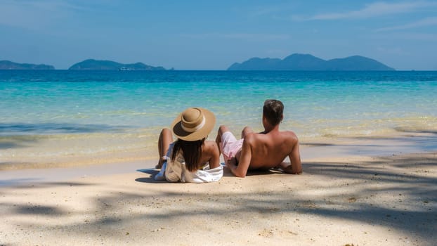 Koh Wai Island Trat Thailand is a tinny tropical Island near Koh Chang. a young couple of men and women on a tropical beach during a luxury vacation in Thailand relaxing on the beach