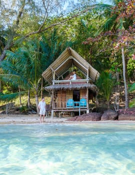 Koh Wai Island Trat Thailand is a tinny tropical Island near Koh Chang. wooden bamboo hut bungalow on the beach. a young couple of men and woman on a tropical Island in Thailand on a sunny morning