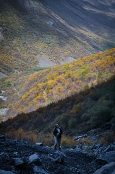 The girl admires the beauty of the mountains, contemplating the amazing landscape