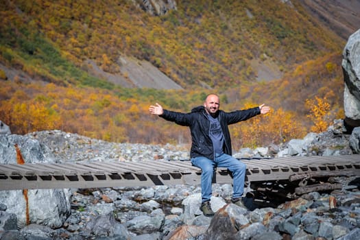 Peace in the mountains: a man enjoys the beauty of nature, surrounded by peaks and silence