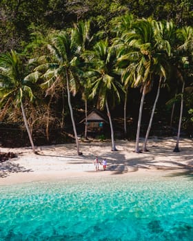 drone view at Koh Wai Island Trat Thailand is a tinny tropical Island near Koh Chang. wooden bamboo hut bungalow on the beach. a young couple of men and woman on a tropical Island in Thailand