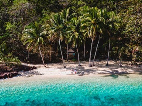 drone view at Koh Wai Island Trat Thailand is a tinny tropical Island near Koh Chang. wooden bamboo hut bungalow on the beach. a young couple of men and woman on a tropical Island in Thailand