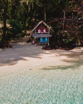 Koh Wai Island Trat Thailand near Koh Chang. wooden bamboo hut bungalow on the beach. a young couple of men and woman on a tropical Island in Thailand