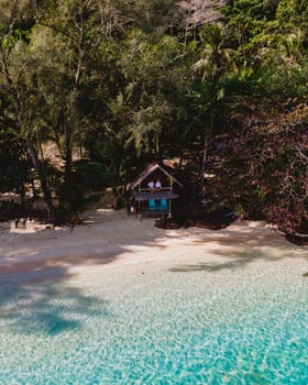 Koh Wai Island Trat Thailand. wooden bamboo hut bungalow on the beach. a young couple of men and woman on a tropical Island in Thailand