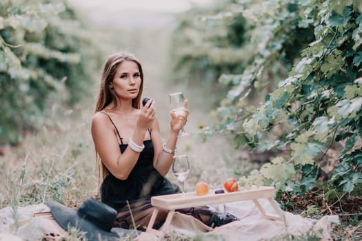 Picnic and wine tasting at sunset in the hills of Italy, Tuscany. Vineyards and open nature in the summer. Romantic dinner, fruit and wine.