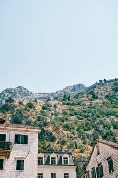 Old stone buildings and the Chapel of Our Lady of Salvation in the mountain. Kotor, Montenegro. High quality photo