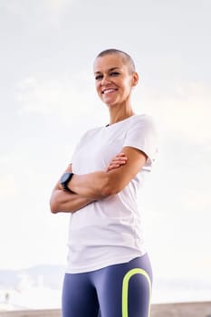 sports woman smiling happy with arms crossed looking at camera, concept of active and healthy lifestyle