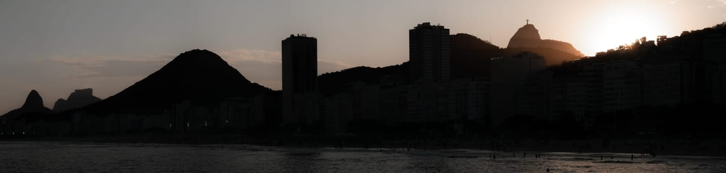 Twilight descends on Rio, casting the city's famous outline in a warm glow.