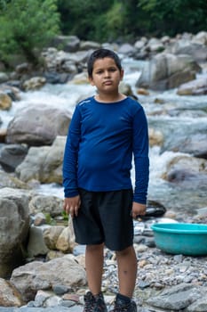 A boy stands, absorbing the rhythm of nature's timeless flow.