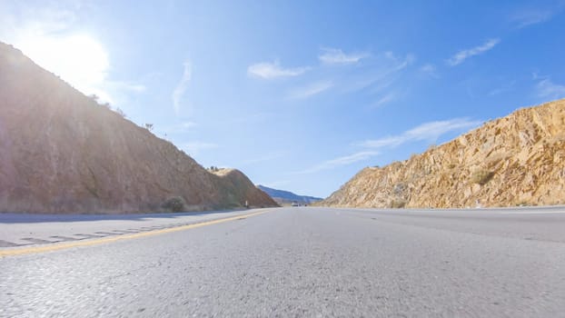 Embarking on a road trip from Nevada to California, driving on Highway 15 during the day offers scenic views and an exciting journey between states.