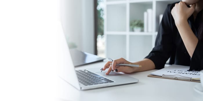 businesswoman working about project with laptop computer and papers working at office. copy space.