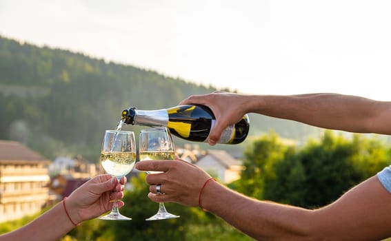 A woman drinks wine against the backdrop of mountains. Selective focus. travel.