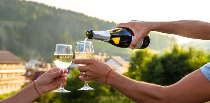 A woman drinks wine against the backdrop of mountains. Selective focus. travel.