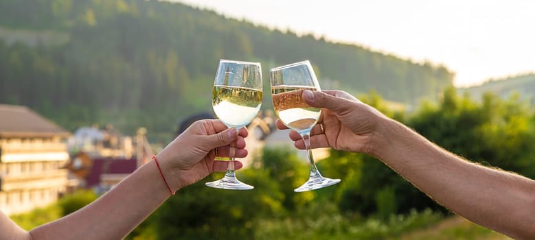 A woman drinks wine against the backdrop of mountains. Selective focus. travel.