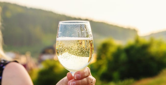 A woman drinks wine against the backdrop of mountains. Selective focus. travel.