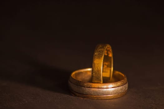 The well worn wedding bands of a couple celebrating many decades of marraige