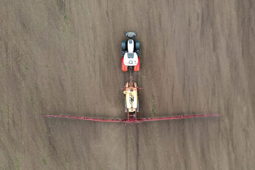 Top view of tractor spraying grain on a field.