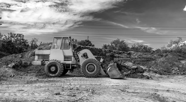 A bulldozer or loader moves the earth during the construction. Heavy equipment for earthworks