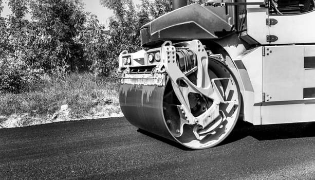 Close view of drum roller at the construction site, working on the new road 