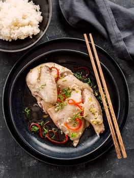 Sous Vide Chicken with spices. Boiled chicken sous-vide on black plate. Sous-vide is culinary method of long-term cooking