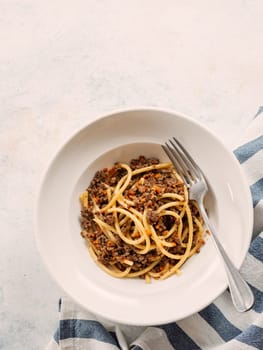 Spaghetti bolognese with minced meat or Makarony Po Flotski or Russian Navy Style Pasta. Top view. Navy spaghetti in plate, copy space.