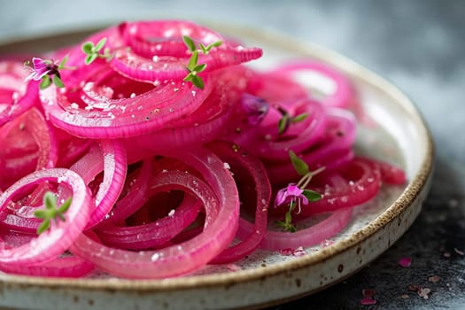Red pickled onion rings lie on a gray background. Selective focus.