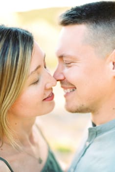 Young woman almost kisses smiling man. Portrait. High quality photo