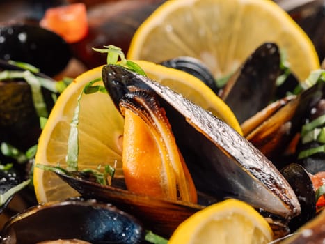 cooked mussels with lemon on white plate. Restaurant-style seafood plating. Seafood and mossels food background