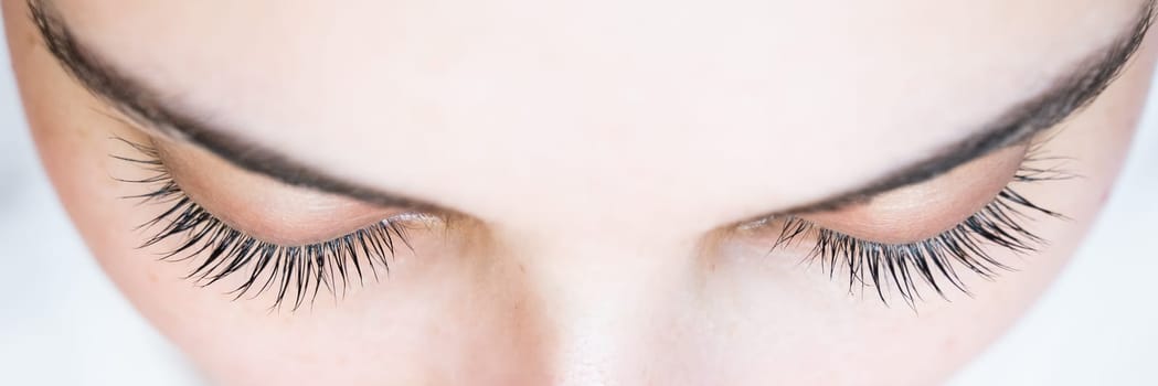 Close-up of a caucasian woman after eyelash lamination procedure