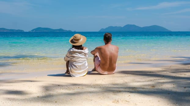 Koh Wai Island Trat Thailand is a tinny tropical Island near Koh Chang. a young couple of men and women sitting on a tropical beach during a luxury vacation in Thailand