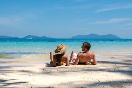 Koh Wai Island Trat Thailand is a tinny tropical Island near Koh Chang. a young couple of men and women sitting on a tropical beach during a luxury vacation in Thailand