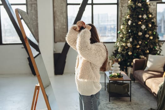 In a joyful moment, a lively young woman wearing a Christmas reindeer mask smiles brightly at home. High quality photo