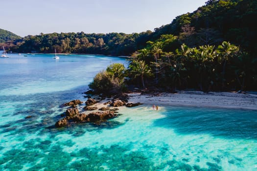 Drone aerial view at Koh Wai Island Trat Thailand is a tinny tropical Island near Koh Chang. a young couple of men and women on a tropical beach during vacation in Thailand