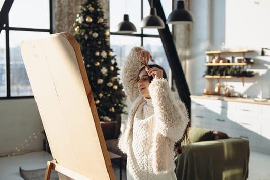 In her apartment, a vibrant young girl styles her hair for a Christmas party in front of the mirror. High quality photo