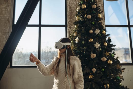 Engrossed in virtual reality, a vibrant young woman enjoys a sunny winter morning. High quality photo