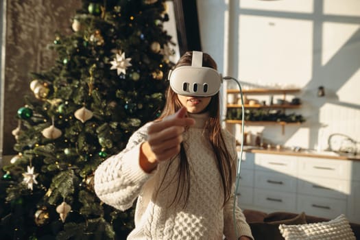 A depiction of a stunning girl in a virtual reality headset, posed near a Christmas tree. High quality photo