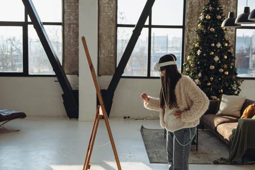 With the holiday ambiance prevailing, a young woman in light attire and a VR headset gazes into the mirror. High quality photo