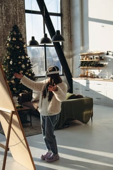 In the midst of Christmas cheer, a young lady in light attire and a VR headset admires herself in the mirror. High quality photo