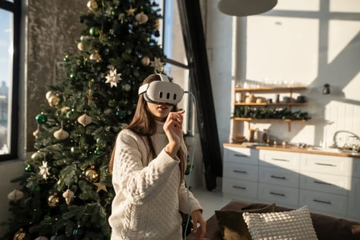 A bright young woman wearing a virtual reality headset on a sunny winter morning. High quality photo