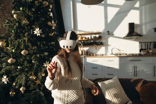 The image portrays a stunning girl in a virtual reality headset against the backdrop of a Christmas tree. High quality photo