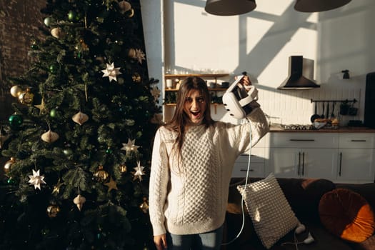 As part of her Christmas gifts, a lively young woman received a virtual reality headset. High quality photo