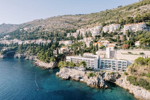 Expensive hotel Villa Dubrovnik on a mountainside with a multi-tiered stone beach by the sea. Croatia. High quality photo