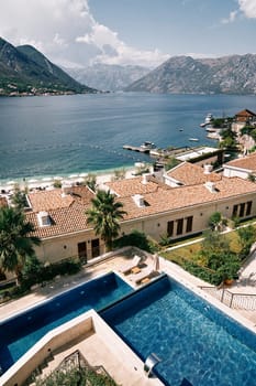 Swimming pools in the hotel garden on the seashore with a mountain range in the background. High quality photo